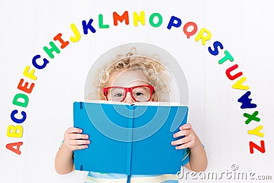 Child learning letters of alphabet and reading Stock Photo