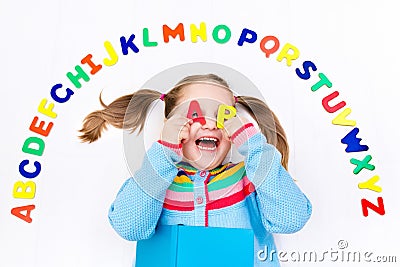 Child learning letters of alphabet and reading Stock Photo