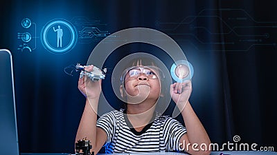 Child learning repairing getting lesson control toy drone in workshop, coding and solving engineering problem at home. Little Stock Photo