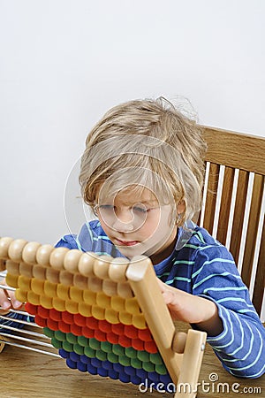 Child learning to count on an abacus Stock Photo