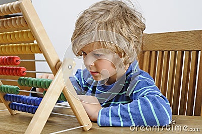 Child learning to use an abacus Stock Photo