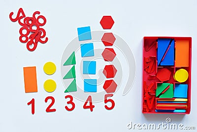 The child learns Number line and geometric shapes. The preschooler works with Montessori material. Educational logic toys for kid Stock Photo