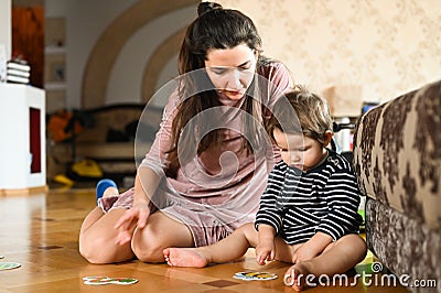 The child learns through pictures. Baby boy and insects. Mom and baby study insects Stock Photo