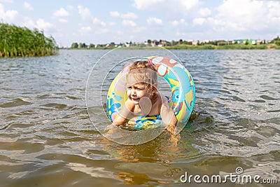 Child learns to swim. child swims in a swimming circle Stock Photo