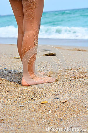 Child legs on sand on a beach Stock Photo