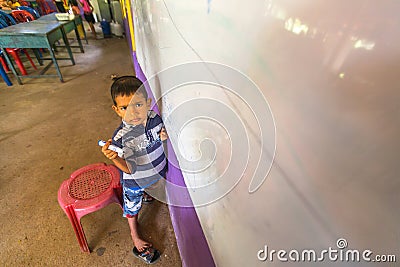Child in lesson at school by project Cambodian Kids Care to help deprived children in deprived areas with education Editorial Stock Photo