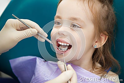 Child lies in dentist chair and doctor does checkup Stock Photo