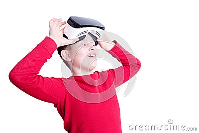 Child lifts up virtual reality headset to see Stock Photo