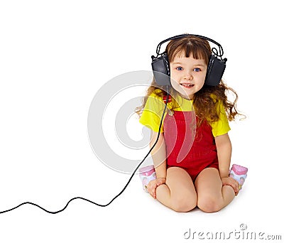 Child listens attentively to music on white Stock Photo