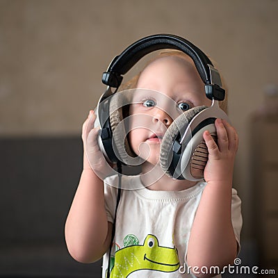 Child listens to music on headphones Stock Photo