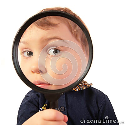 Child look through magnifier Stock Photo