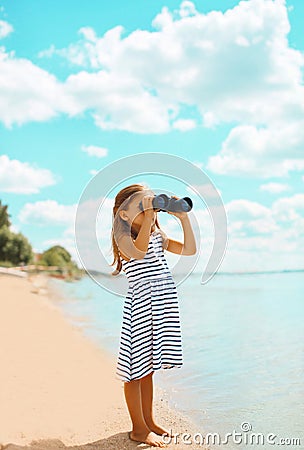 Child looking through binoculars in the expanse Stock Photo