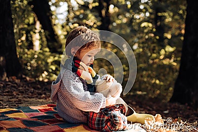 Child love. Atumn fun at the park. Happy kids autumn. Cute boy with Autumn Leaves on Fall Nature Background. Stock Photo