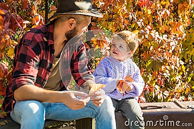 Child love. Childhood concept. Parent teach baby. Father and child son in autumn park having fun and laughing. Childhood Stock Photo