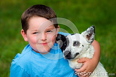 Child lovingly embraces his pet Stock Photo