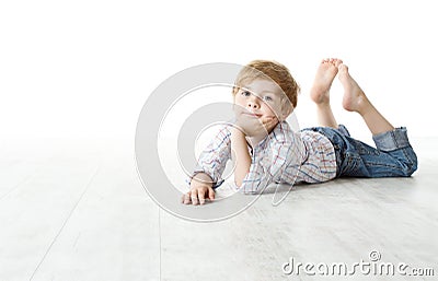 Child lying down on floor and looking at camera Stock Photo