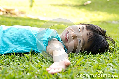 Child lying on grass Stock Photo