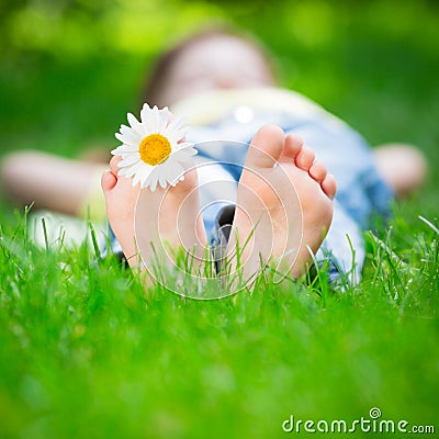 Child lying on grass Stock Photo