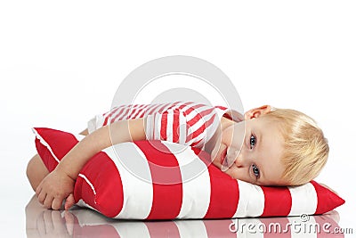 Child lying with pillow Stock Photo