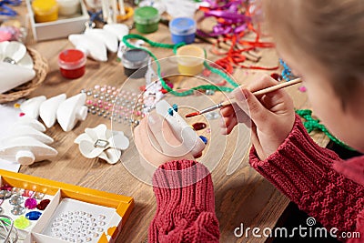 Child make crafts and toys, handmade concept. Artwork workplace with creative accessories. Stock Photo