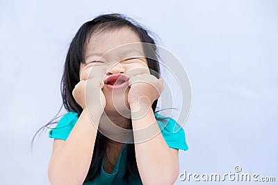 Child make funny faces. Kids puts his hands feet and chin and does freaky face. Cute baby good mood. Stock Photo