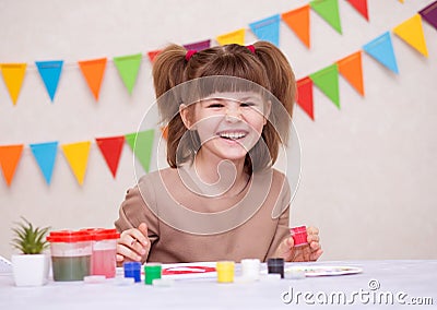 Child making homemade greeting card. Little girl paints heart on homemade greeting card as gift for Mother Day. Traditional play Stock Photo