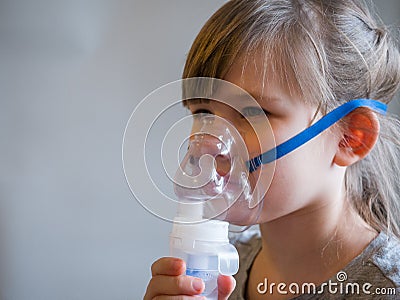 Child making inhalation with mask on his face. Asthma problems concept Stock Photo