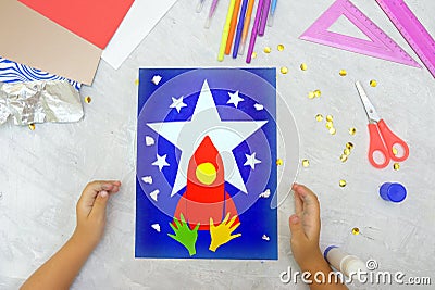 Child making rocket and stars from paper. Creative children play with craft. The space theme development of children. School Stock Photo