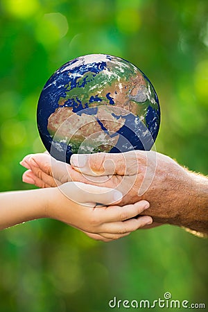 Child and man holding Earth in hands Stock Photo