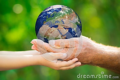 Child and man holding Earth in hands Stock Photo