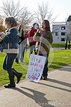 A child with a megaphone and a placard saying Editorial Stock Photo