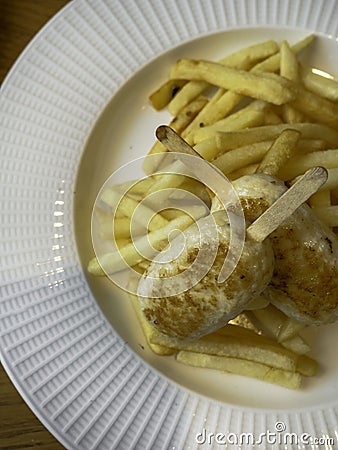 Child menu - french fries and chicken cutlets in the form of popsicle Stock Photo