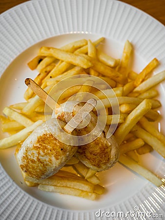 Child menu - french fries and chicken cutlets in the form of popsicle Stock Photo