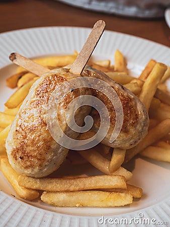 Child menu - french fries and chicken cutlets in the form of popsicle Stock Photo