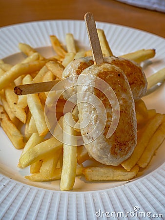 Child menu - french fries and chicken cutlets in the form of popsicle Stock Photo