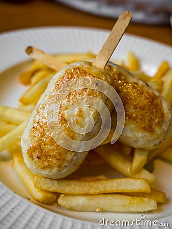 Child menu - french fries and chicken cutlets in the form of popsicle Stock Photo