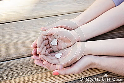 Child and mother holding heart in hands Stock Photo