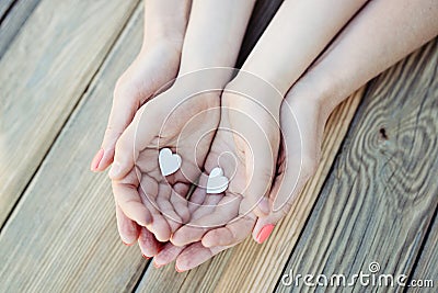 Child and mother holding heart in hands Stock Photo