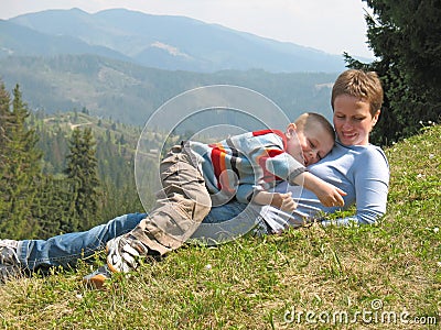 Child and mother play on grass Stock Photo