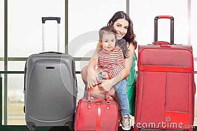 Child with mother ready to travel. Airport terminal. Stock Photo