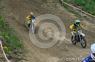 LVIV, UKRAINE - MAY, 2019: Child motorcycle racer rides and jumps on an enduro motorcycle on a motocross track Editorial Stock Photo