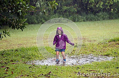 Child in muddy puddle Stock Photo