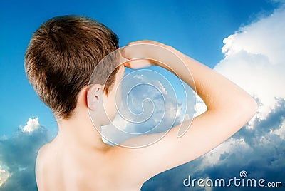 Child observes restless sky Stock Photo