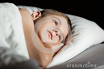 Child with open eyes with head on pillow Stock Photo