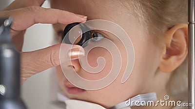 Child in ophthalmology clinic - optometrist diagnosis little blonde girl Stock Photo