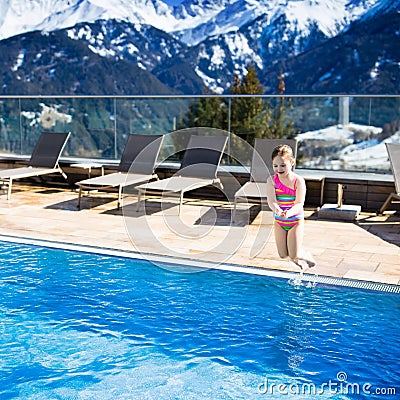 Child in outdoor swimming pool of alpine resort Stock Photo