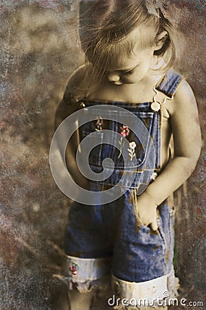 Child in overalls in vintage tones Stock Photo