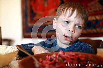 Child overeat salad of beetroot Stock Photo