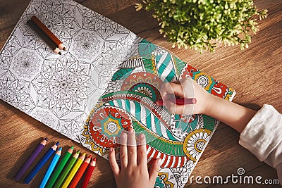 Child paint a coloring book Stock Photo