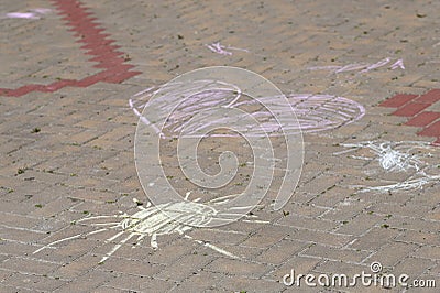 child painted the sun and heart on the pavement with colored chalk Stock Photo